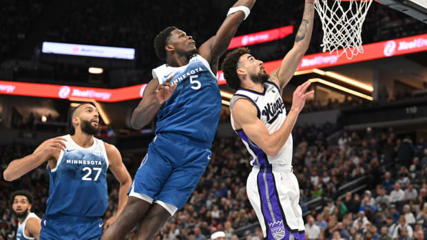 Nov 24, 2023; Minneapolis, Minnesota, USA; Minnesota Timberwolves guard Anthony Edwards (5) blocks the shot of Sacramento Kings guard Chris Duarte (3) as center Rudy