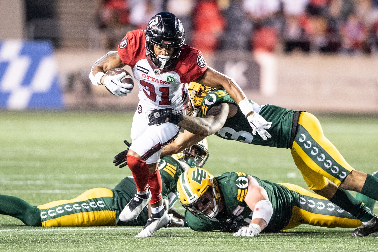 Aug 19, 2022; Ottawa, Ontario, CAN; Ottawa REDBLACKS running back Devonte Williams (31) runs the ball in the first half against the Edmonton Elks at the TD Place stadium. Mandatory Credit: Marc DesRosiers-USA TODAY Sports