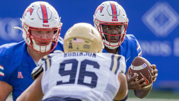 Ponies backup quarterback Kevin Jennings takes a snap against Navy