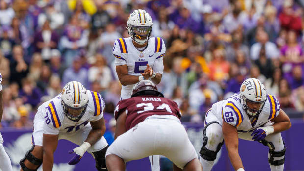 Nov 25, 2023; Baton Rouge, Louisiana, USA; LSU Tigers quarterback Jayden Daniels (5) calls for the ball against Texas A&M Aggies defensive lineman Isaiah Raikes (34) during the second half at Tiger Stadium.