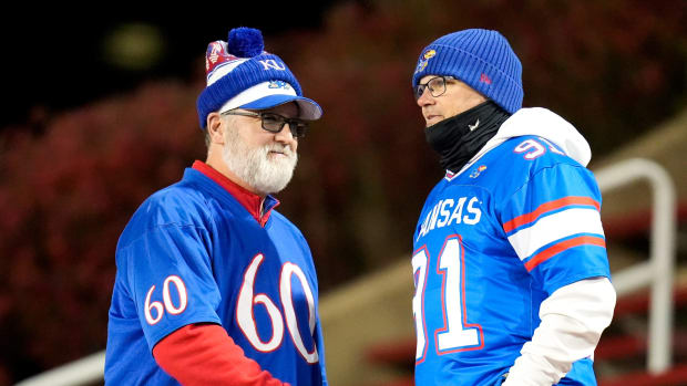 Kansas Jayhawks fans shake hands prior to the NCAA college football game between the Cincinnati Bearcats and Kansas Jayhawks on Saturday, Nov. 25, 2023, at Nippert Stadium in Cincinnati. This is the Bearcats last game of the season, as well as their Senior Night Saturday.  