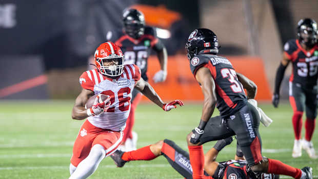 Jun 15, 2023; Ottawa, Ontario, CAN; Calgary Stampeders running back Dedrick Mills (26) runs the ball in the second half against the Ottawa REDBLACKS at TD Place. Mandatory Credit: Marc DesRosiers-USA TODAY Sports