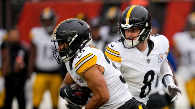 Pittsburgh Steelers quarterback Kenny Pickett (8) hands off to running back Jaylen Warren (30) in the second quarter of the NFL Week 12 game between the Cincinnati Bengals and the Pittsburgh Steelers at Paycor Stadium in Cincinnati on Sunday, Nov. 26, 2023.