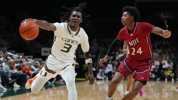 Nov 6, 2023; Coral Gables, Florida, USA; Miami (Fl) Hurricanes guard Christian Watson (3) grabs possession as N.J.I.T Highlanders guard Mekhi Gray (24) defends in the first half at Watsco Center. Mandatory Credit: Jim Rassol-USA TODAY Sports  