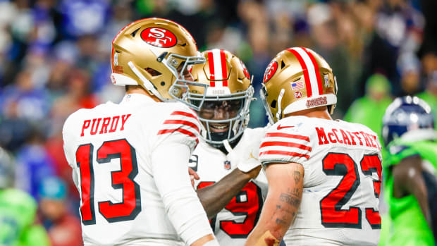 Nov 23, 2023; Seattle, Washington, USA; San Francisco 49ers running back Christian McCaffrey (23) celebrates with quarterback Brock Purdy (13) and wide receiver Deebo Samuel (19) after catching a touchdown pass from Purdy against the Seattle Seahawks during the second quarter at Lumen Field. Mandatory Credit: Joe Nicholson-USA TODAY Sports  