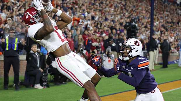 Nov 25, 2023; Auburn, Alabama, USA; Alabama Crimson Tide wide receiver Isaiah Bond (17) scores the game winning touchdown over Auburn Tigers cornerback D.J. James (4) during the fourth quarter at Jordan-Hare Stadium. Mandatory Credit: John Reed-USA TODAY Sports