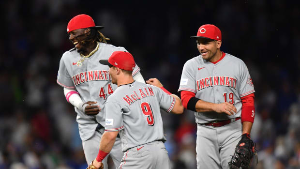 Jul 31, 2023; Chicago, Illinois, USA; Cincinnati Reds third baseman Elly De La Cruz (44), shortstop Matt McLain (9), and first baseman Joey Votto (19) celebrate their victory over the Chicago Cubs at Wrigley Field. Mandatory Credit: Patrick Gorski-USA TODAY Sports  