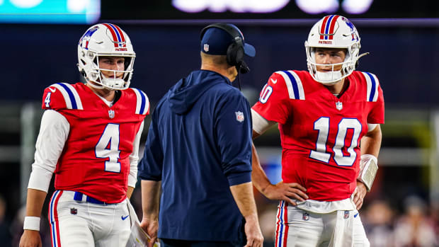 Sep 17, 2023; Foxborough, Massachusetts, USA; New England Patriots quarterback Mac Jones (10) and quarterback Bailey Zappe (4) talk with offensive coordinator/quarterbacks coach Bill O'Brien in the second quarter at Gillette Stadium. Mandatory Credit: David Butler II-USA TODAY Sports  