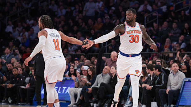Nov 30, 2023; New York, New York, USA; New York Knicks forward Julius Randle (30) slaps hands with guard Jalen Brunson (11) after a basket during the second half against the Detroit Pistons at Madison Square Garden.