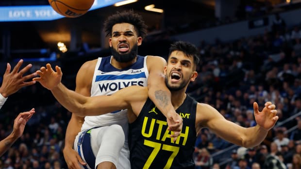 Nov 30, 2023; Minneapolis, Minnesota, USA; Minnesota Timberwolves forward Karl-Anthony Towns (32) and Utah Jazz center Omer Yurtseven (77) watch a loose ball go in the third quarter at Target Center.