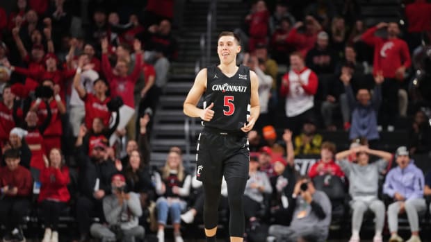 Cincinnati Bearcats guard CJ Fredrick (5) reacts to a made 3-point basket in the second half during an NCAA college basketball game between Georgia Tech Yellow Jackets and the Cincinnati Bearcats, Wednesday, Nov. 22, 2023, at Fifth Third Arena in Cincinnati.