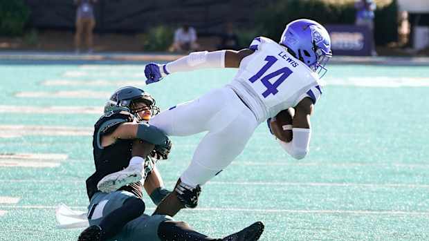 Nov 13, 2021; Conway, South Carolina, USA; Coastal Carolina Chanticleers cornerback Alex Spillum (10) tackles Georgia State Panthers Robert Lewis (14) at Brooks Stadium. Mandatory Credit: David Yeazell-USA TODAY Sports