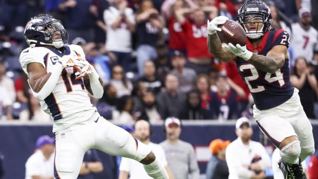 Houston Texans cornerback Derek Stingley Jr. (24) intercepts a pass intended for Denver Broncos wide receiver Courtland Sutton (14) during the fourth quarter at NRG Stadium.