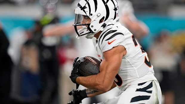 Cincinnati Bengals running back Chase Brown (30) takes a carry from Cincinnati Bengals quarterback Jake Browning (6) in the first half of a Week 13 NFL football game against the Jacksonville Jaguars, Monday, Dec. 4, 2023, at EverBank Stadium in Jacksonville, Fla.