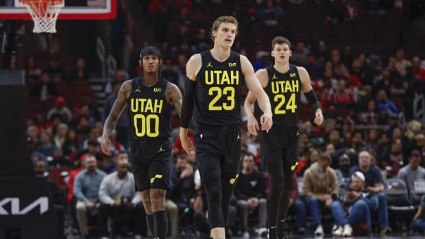 Utah Jazz forward Lauri Markkanen (23), Utah Jazz guard Jordan Clarkson (00) and Utah Jazz center Walker Kessler (24) walk on the court during the first half of a basketball game against the Chicago Bulls at United Center.