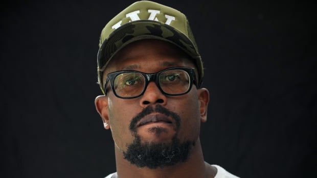 Bills pass rusher Von Miller looks on while speaking with reporters at a press conference.