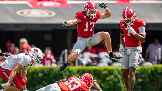 Sep 9, 2023; Athens, Georgia, USA; Georgia Bulldogs defensive back Dan Jackson (17) jumps over players after a play against the Ball State Cardinals during the second half at Sanford Stadium. Mandatory Credit: Dale Zanine-USA TODAY Sports