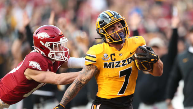 Missouri Tigers running back Cody Schrader (7) rushes against the Arkansas Razorbacks during the second quarter at Donald W. Reynolds Razorback Stadium.