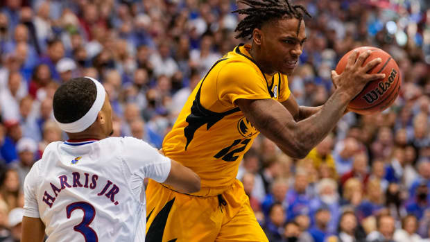 Dec 11, 2021; Lawrence, Kansas, USA; Missouri Tigers guard DaJuan Gordon (12) grabs a loose ball against Kansas Jayhawks guard Dajuan Harris Jr. (3) during the first half at Allen Fieldhouse. Mandatory Credit: Jay Biggerstaff-USA TODAY Sports  