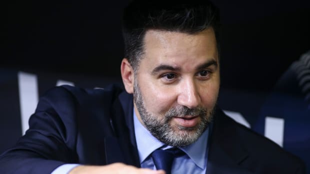 Oct 25, 2021; Houston, Texas, USA; Atlanta Braves general manager Alex Anthopoulos talks in the dugout during workouts before Game 1 of the World Series between the Houston Astros and the Atlanta Braves at Minute Maid Park.
