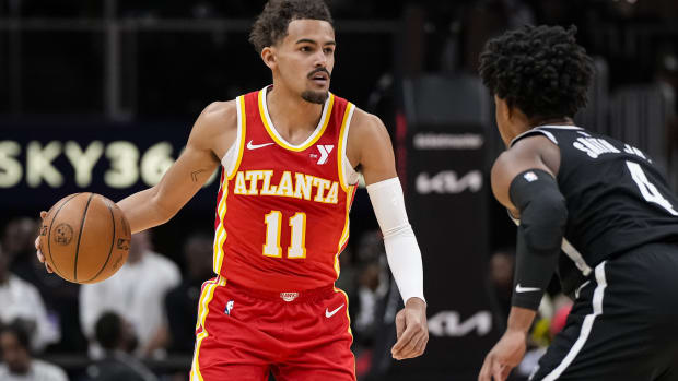 Atlanta Hawks guard Trae Young (11) controls the ball against Brooklyn Nets guard Dennis Smith Jr. (4) 