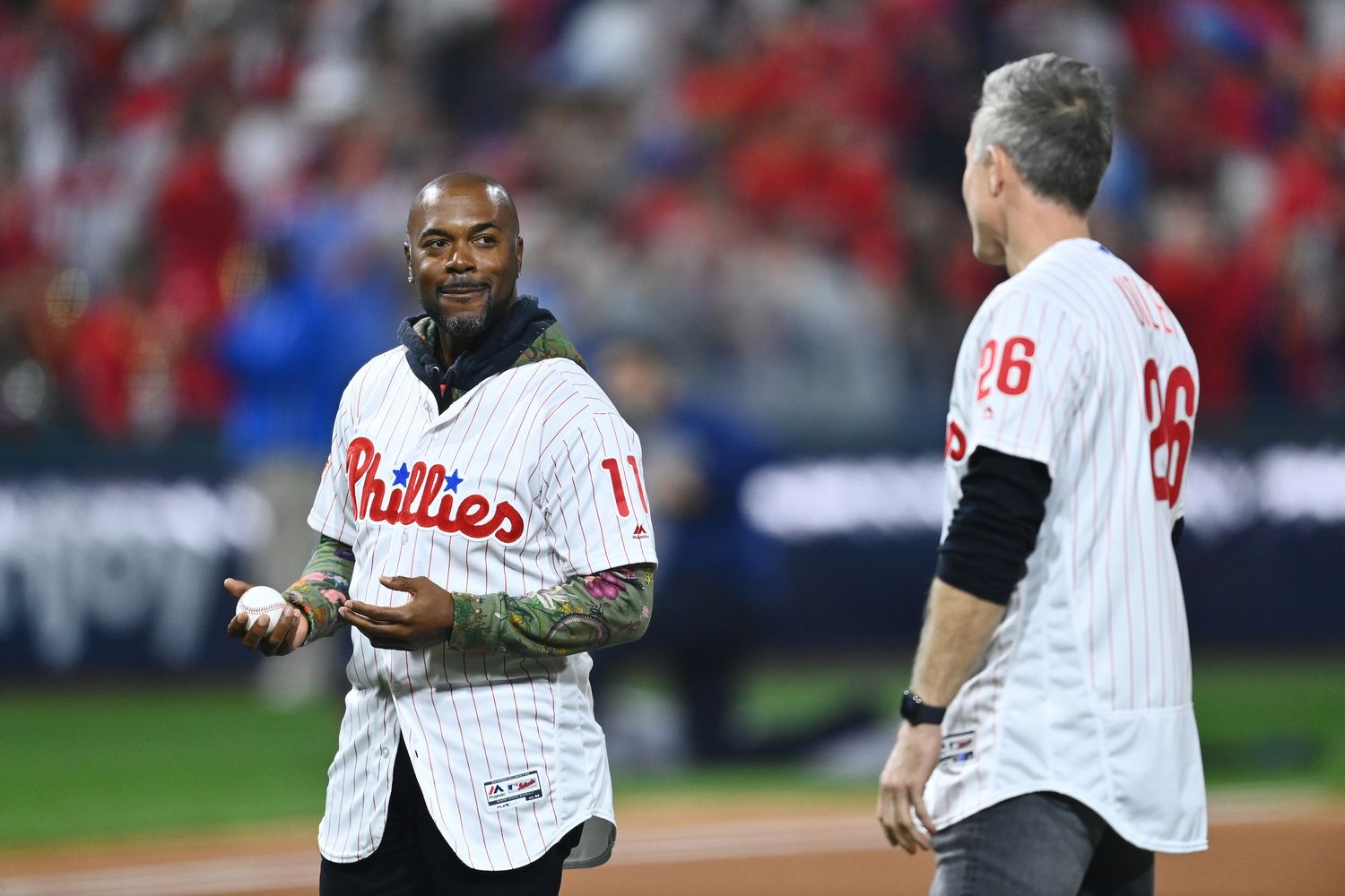 Nov 2, 2022; Philadelphia, Pennsylvania, USA; Former Philadelphia Phillies shortstop Jimmy Rollins and former second baseman Chase Utley look on prior to throwing out a ceremonial first pitch before game four of the 2022 World Series against the Houston Astros at Citizens Bank Park.