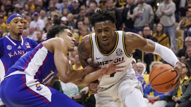 Dec 10, 2022; Columbia, Missouri, USA; Missouri Tigers guard DeAndre Gholston (4) dribbles the ball as Kansas Jayhawks guard Kevin McCullar Jr. (15) defends during the first half at Mizzou Arena. Mandatory Credit: Denny Medley-USA TODAY Sports  