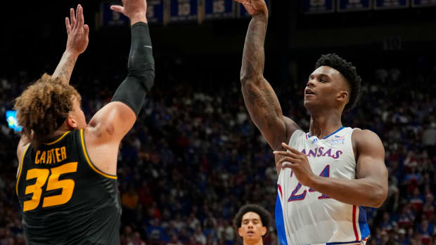 Dec 9, 2023; Lawrence, Kansas, USA; Kansas Jayhawks forward K.J. Adams Jr. (24) passes the ball over Missouri Tigers forward Noah Carter (35) during the second half at Allen Fieldhouse. 