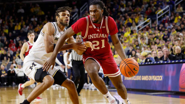 Dec 5, 2023; Ann Arbor, Michigan, USA; Indiana Hoosiers forward Mackenzie Mgbako (21) dribbles against Michigan Wolverines forward Tray Jackson (2) in the second half at Crisler Center.