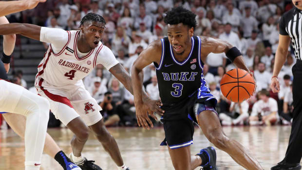 Nov 29, 2023; Fayetteville, Arkansas, USA; Duke Blue Devils guard Jeremy Roach (3) drives against Arkansas Razorbacks guard Davonte Davis (4) during the first half at Bud Walton Arena. 