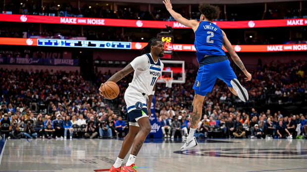 Dec 14, 2023; Dallas, Texas, USA; Minnesota Timberwolves center Naz Reid (11) avoids a leaping Dallas Mavericks center Dereck Lively II (2) during the second quarter at the American Airlines Center.