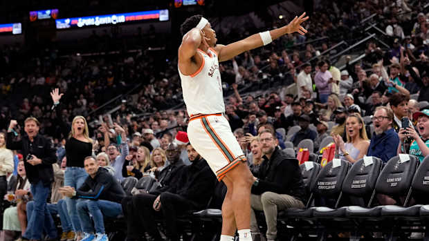 Dec 15, 2023; San Antonio, Texas, USA; San Antonio Spurs forward Keldon Johnson (3) reacts after scoring a three pointer during the first half against the Los Angeles Lakers at Frost Bank Center.