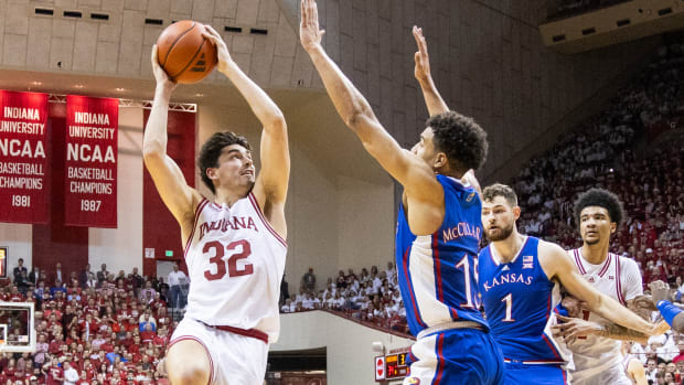 Dec 16, 2023; Bloomington, Indiana, USA; Indiana Hoosiers guard Trey Galloway (32) shoots the ball while Kansas Jayhawks guard Kevin McCullar Jr. (15) defends in the first half at Simon Skjodt Assembly Hall.