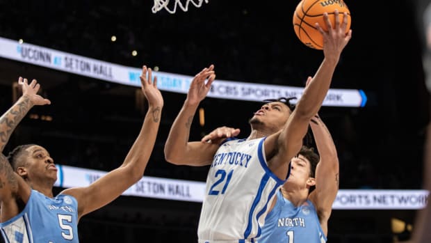 Dec 16, 2023; Atlanta, Georgia, USA; Kentucky Wildcats guard D.J. Wagner (21) attempts layup shot against North Carolina Tar Heels forward Armando Bacot (5) and North Carolina Tar Heels forward Zayden High (1) during the first half at State Farm Arena. Mandatory Credit: Jordan Godfree-USA TODAY Sports