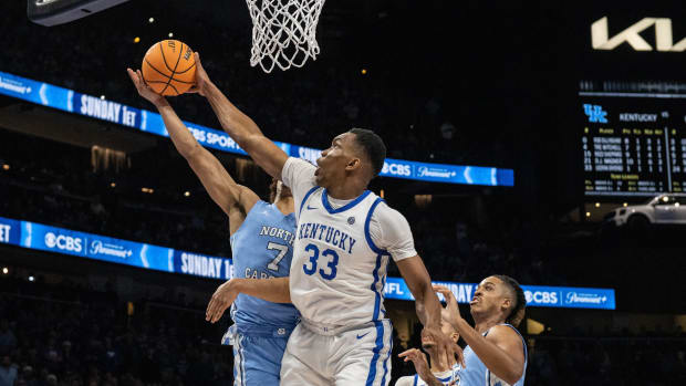Dec 16, 2023; Atlanta, Georgia, USA; Kentucky Wildcats forward Ugonna Onyenso (33) blocks the shot by North Carolina Tar Heels guard Seth Trimble (7) during the second half at State Farm Arena. Mandatory Credit: Jordan Godfree-USA TODAY Sports 