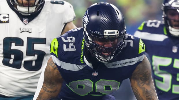 Seattle Seahawks defensive end Leonard Williams (99) tackles Philadelphia Eagles running back D'Andre Swift (0) for a loss during the first quarter at Lumen Field.