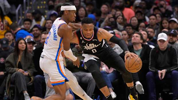 Mar 23, 2023; Los Angeles, California, USA; Los Angeles Clippers guard Russell Westbrook (0) drives past Oklahoma City Thunder guard Shai Gilgeous-Alexander (2) in the second half at Crypto.com Arena.