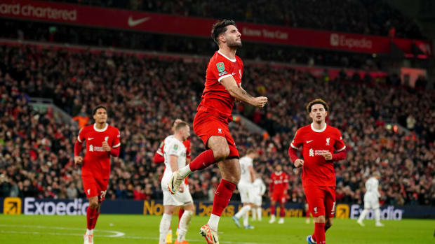 Dominik Szoboszlai pictured (center) celebrating after scoring a long-range goal for Liverpool against West Ham in an EFL Cup quarter-final at Anfield in December 2023