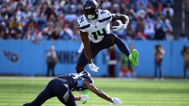 Seattle wide receiver DK Metcalf hurdles a Tennessee Titans defender during Sunday's game at Nissan Stadium.