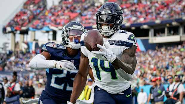 Seattle Seahawks wide receiver DK Metcalf (14) pulls in a touchdown past Tennessee Titans cornerback Tre Avery (23) during the fourth quarter at Nissan Stadium in Nashville, Tenn., Sunday, Dec. 24, 2023.