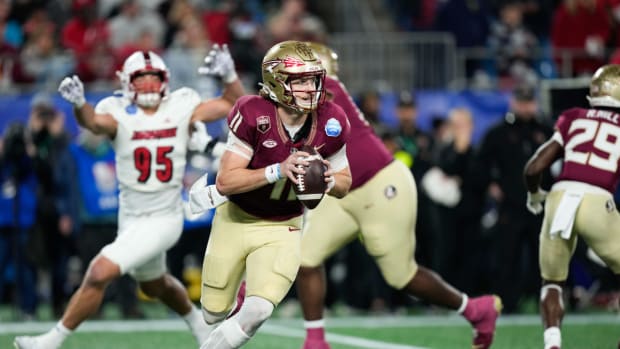 Dec 2, 2023; Charlotte, NC, USA; Florida State Seminoles quarterback Brock Glenn (11) scrambles with the ball against the Louisville Cardinals during the third quarter at Bank of America Stadium. (Jim Dedmon / USA TODAY Sports).