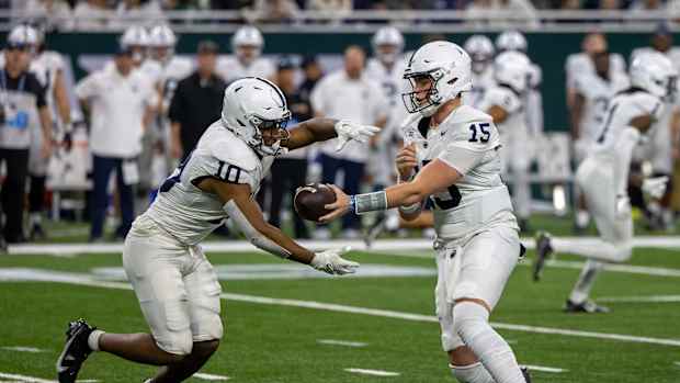 Penn State quarterback Drew Allar hands off to Kaytron Allen against Michigan State.