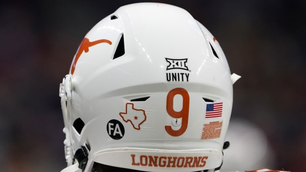 Dec 29, 2020; San Antonio, TX, USA; Detailed view of the \"Unity\" and \"FA\" to honor former coach Fred Akers, who died on Dec. 7 on the back of the helmet of Texas Longhorns wide receiver Al'Vonte Woodard (9) during the Alamo Bowl against the Colorado Buffaloes at the Alamodome. Texas defeated Colorado 55-23. Mandatory Credit: Kirby Lee-USA TODAY Sports