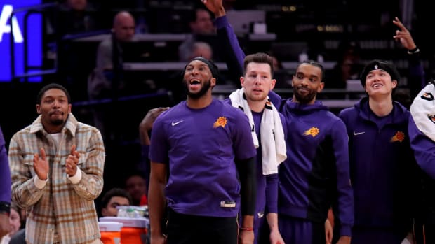 Phoenix Suns bench players react after a made basket against the Houston Rockets during the second quarter at Toyota Center.