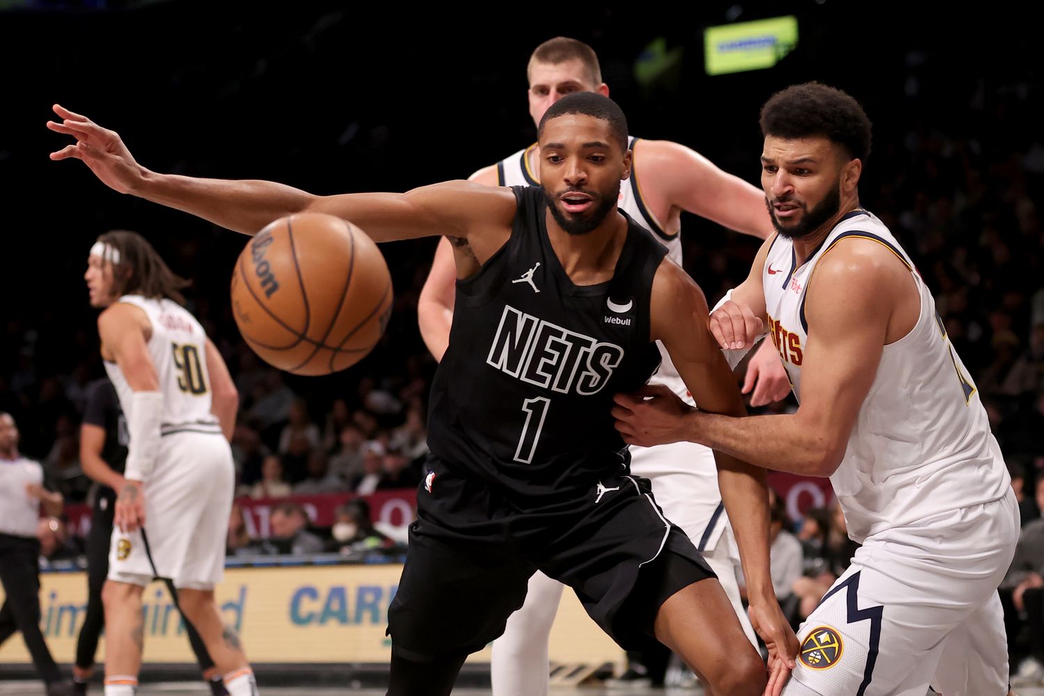 Bridges chases a loose ball during the Nets' 122-117 loss to the Nuggets on Dec. 22, 2023.