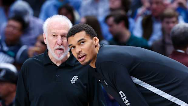 Dec 23, 2023; Dallas, Texas, USA; San Antonio Spurs head coach Gregg Popovich speaks with San Antonio Spurs center Victor Wembanyama (1) before the game against the Dallas Mavericks at American Airlines Center.
