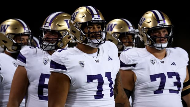 Sep 30, 2023; Tucson, Arizona, USA; Washington Huskies offensive lineman Nate Kalepo (71) and offensive lineman Roger Rosengarten (73) walk onto the field for warmups before a game agaisnt the Arizona Wildcats at Arizona Stadium.