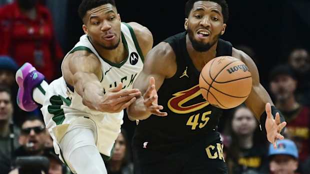 December 29, 2023; Milwaukee Bucks forward Giannis Antetokounmpo and Cleveland Cavaliers guard Donovan Mitchell fight for a loose ball
