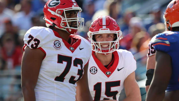 Oct 28, 2023; Jacksonville, Florida, USA; Georgia Bulldogs quarterback Carson Beck (15) calls a play to offensive lineman Xavier Truss (73) against the Florida Gators during the first quarter at EverBank Stadium. (Kim Klement Neitzel / USA TODAY Sports).