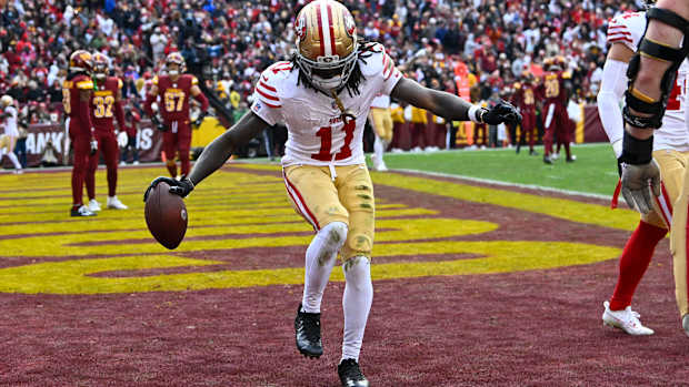 Dec 31, 2023; Landover, Maryland, USA; San Francisco 49ers wide receiver Brandon Aiyuk (11) celebrates after scoring a touchdown against the Washington Commanders during the second half at FedExField. Mandatory Credit: Brad Mills-USA TODAY Sports  